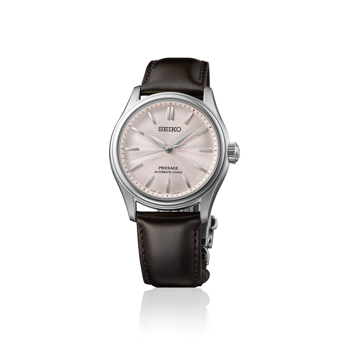 Seiko watch with black leather strap and soft pink dial on a white background