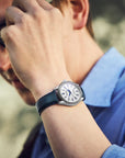 Close-up of a person wearing a watch with a blurred background