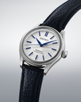 Seiko watch with black leather strap on a light gray background