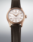 Seiko watch with brown leather strap on a light gray background