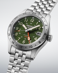 A Seiko dive watch with a green dial, silver stainless steel case and link bracelet, featuring a rotating bezel and a date window.