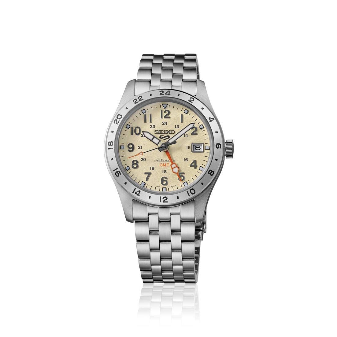 A Seiko wristwatch with a stainless steel link bracelet, featuring a cream-colored dial with black Arabic numerals, a rotating black bezel, and orange accent hands.