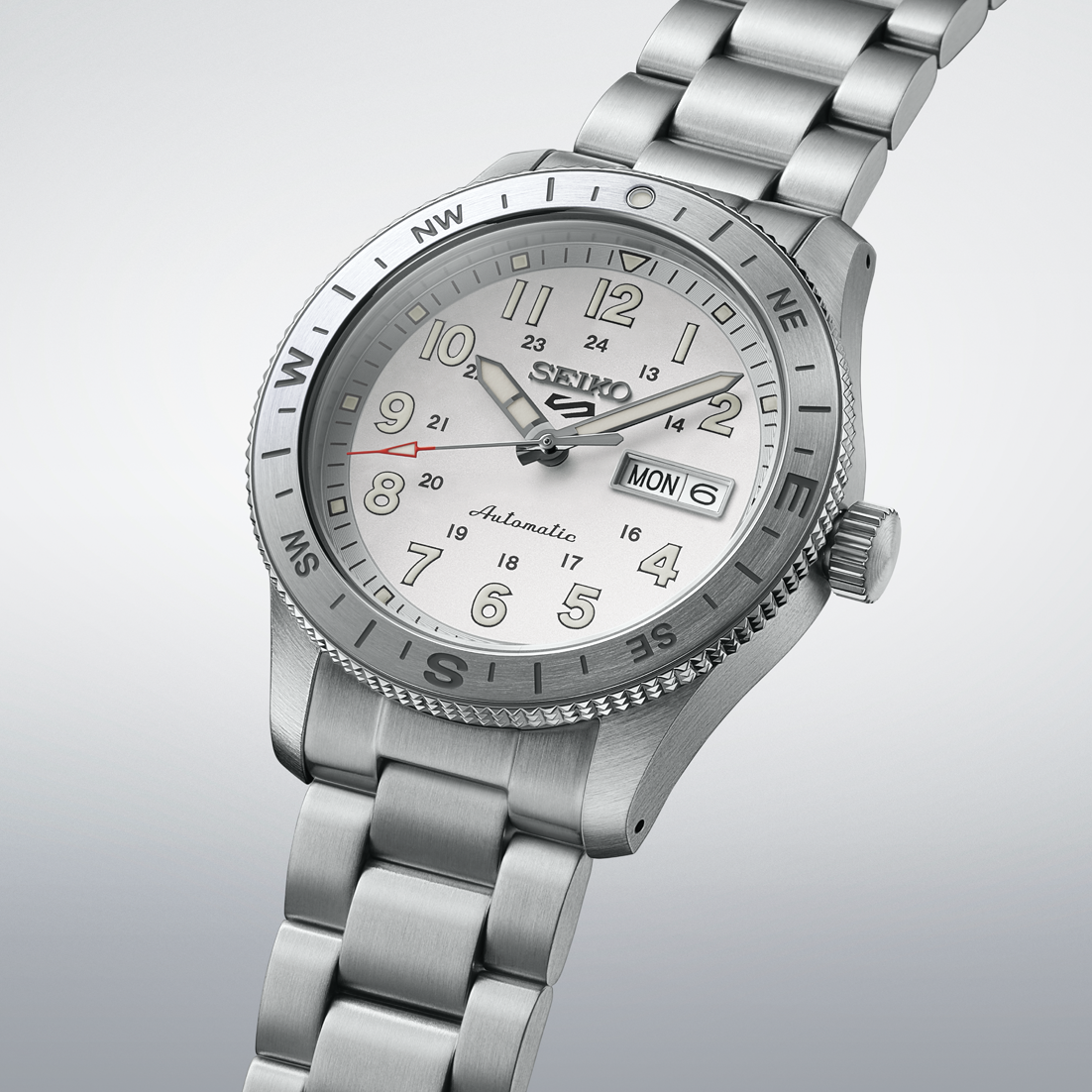 Silver Seiko watch with a detailed face on a light gray background