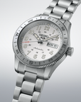 Silver Seiko watch with a detailed face on a light gray background