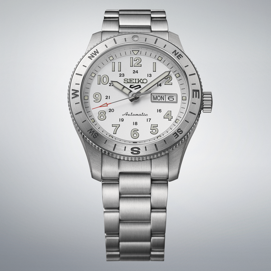 Silver Seiko watch with a detailed face on a gray background