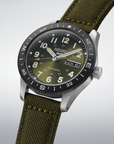 Seiko watch with green strap and green dial on a light gray background- angled