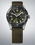 Seiko watch with green strap and face on a light gray background