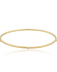 Gold bracelet with small diamond stations on a white background