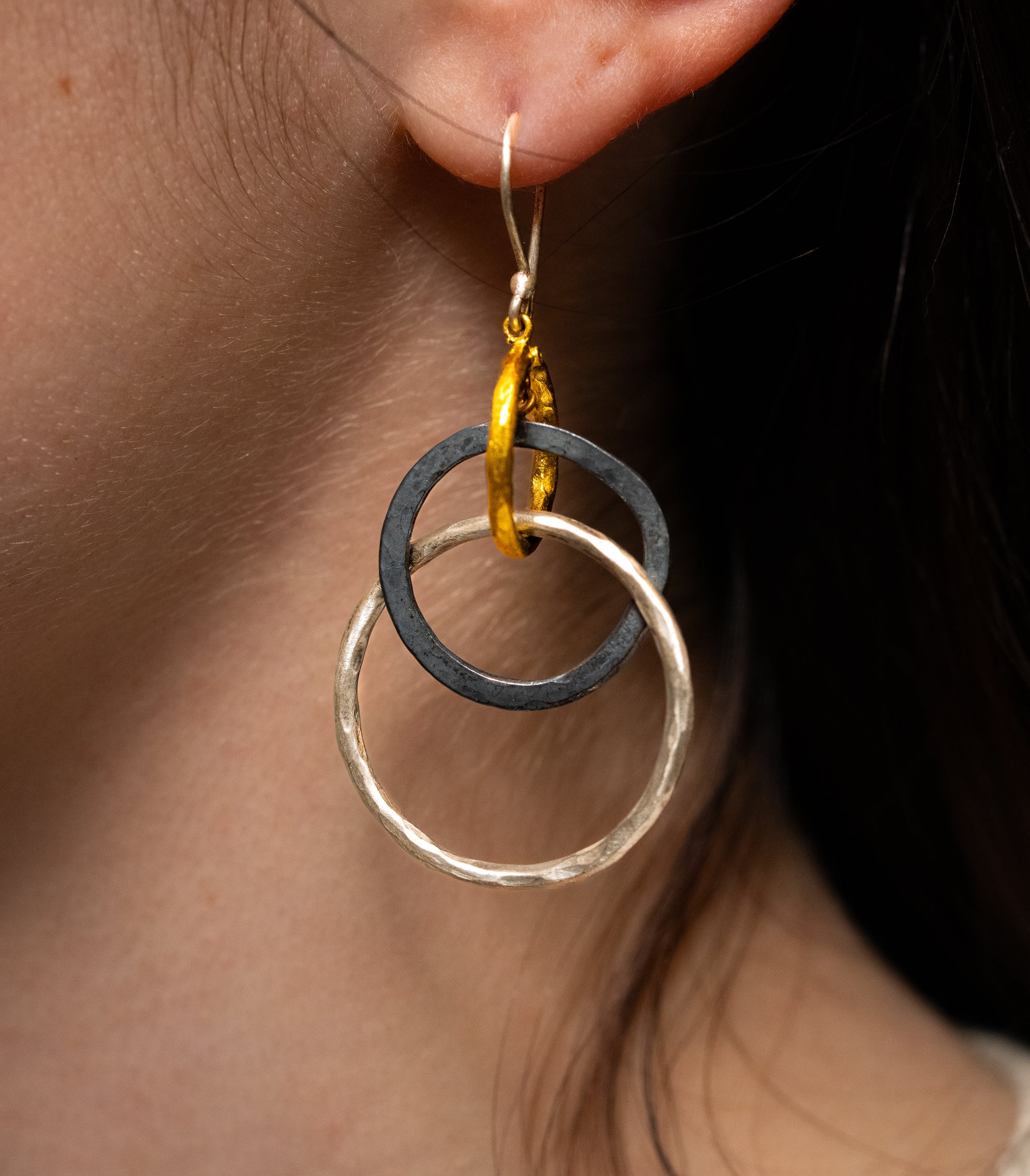 Modeled image of Lika Behar Kelly earrings with gold, oxidized silver, and hammered sterling silver circles.