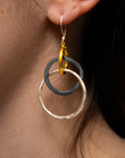 Modeled image of Lika Behar Kelly earrings with gold, oxidized silver, and hammered sterling silver circles.