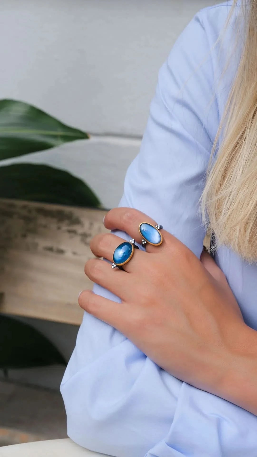 Person wearing two  blue rings with a blue and blurred  background