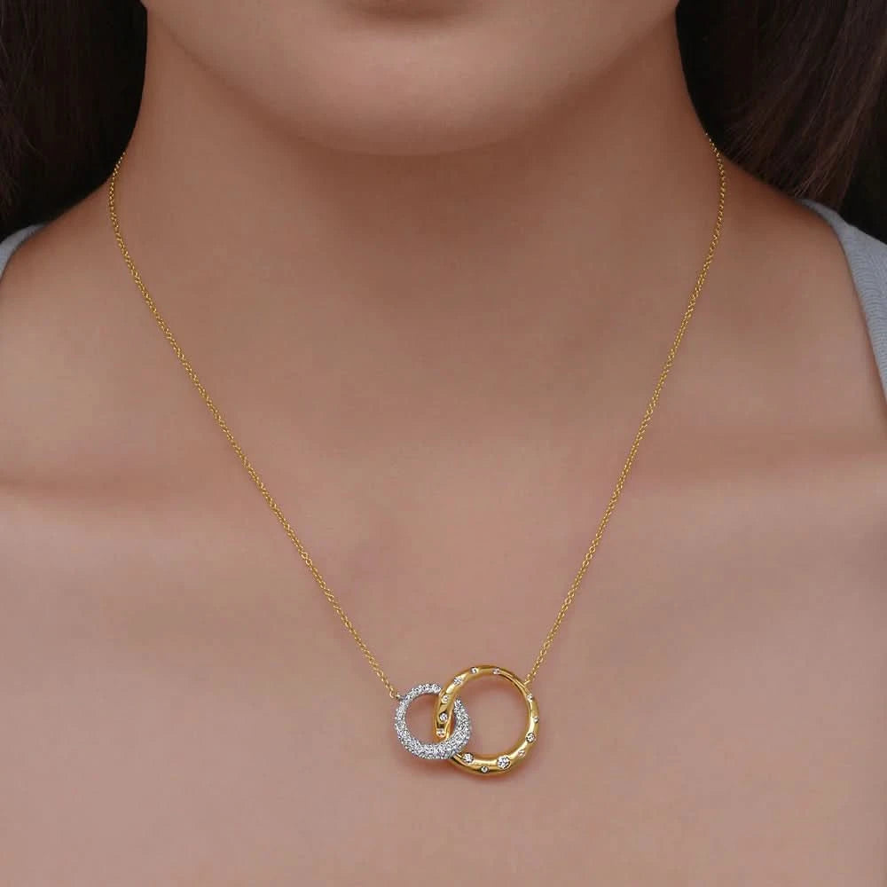 Gold necklace with a double-circle diamond pendant on a model