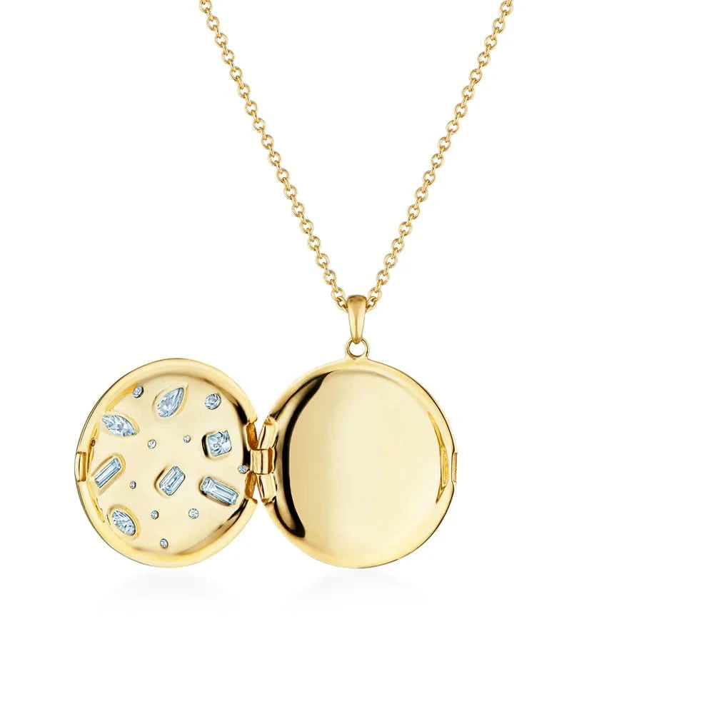 Open yellow gold locket with embedded stones on a white background
