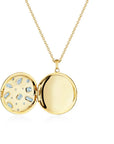 Open yellow gold locket with embedded stones on a white background