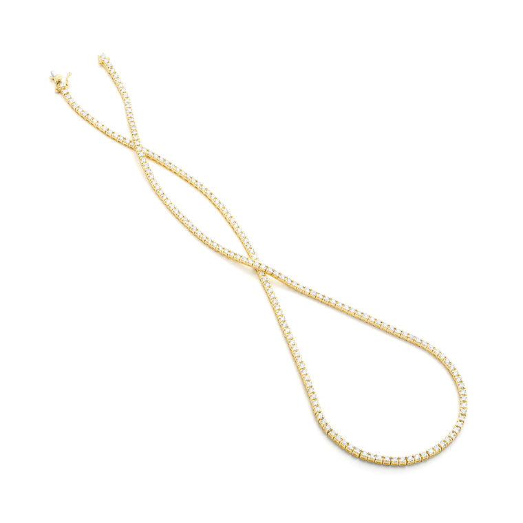 Gold tennis necklace on a white background