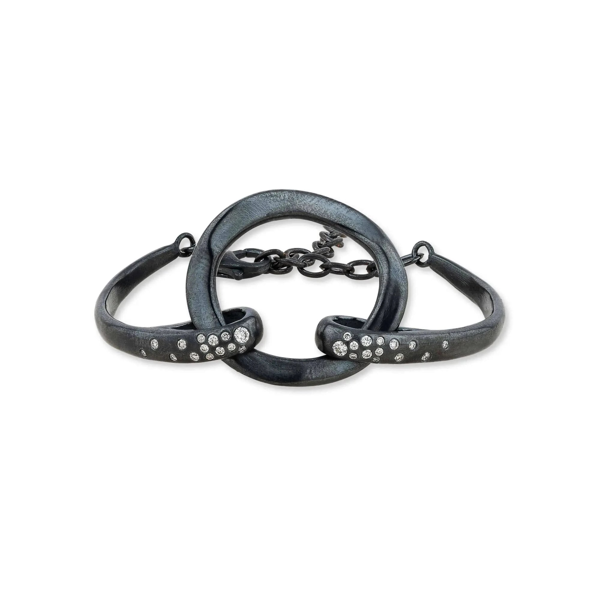 An artisanal Lika Behar "Orion" chain link bracelet crafted in textured, dark oxidized sterling silver, accented with sparkling white diamond stations totaling 0.30 carats.