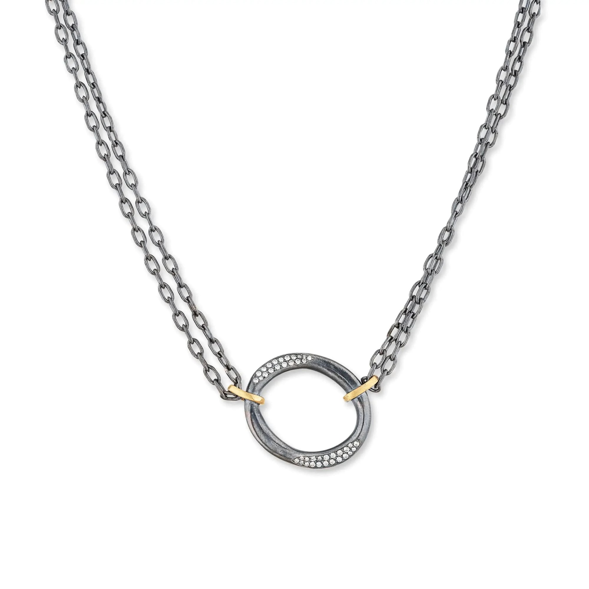 An artisanal Lika Behar "Orion" shield pendant necklace in hand-hammered 24K yellow gold and dark oxidized sterling silver, accented with 0.22 carats of pavé diamonds on an adjustable link chain.