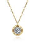 A gold pendant necklace featuring a round yellow gold outer ring and a central halo of small clear stones around a larger clear center stone, suspended from a delicate gold chain on a white background.
