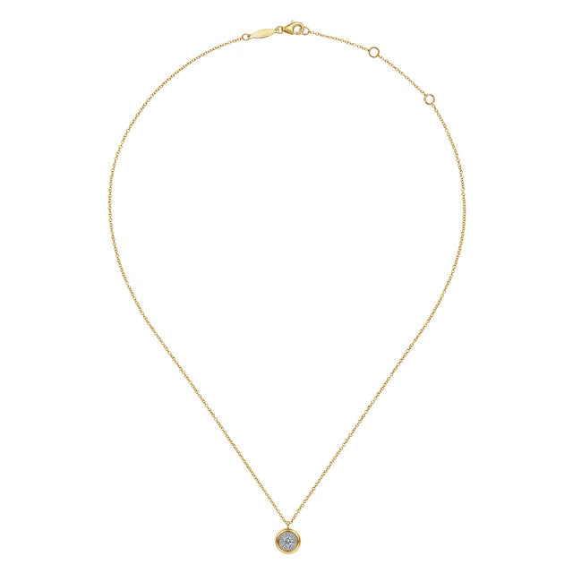 A delicate yellow gold chain necklace with a small round pendant featuring a clear gemstone surrounded by a gold border, displayed on a clean white background.