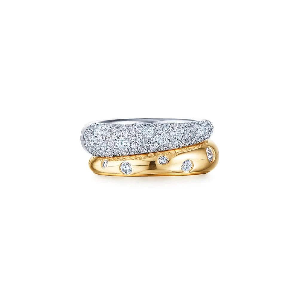 Two rings, one silver and one gold with diamonds, on a white background