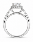 A silver-toned diamond engagement ring with a round center stone and a halo of smaller diamonds, shown on a clean white background. side view
