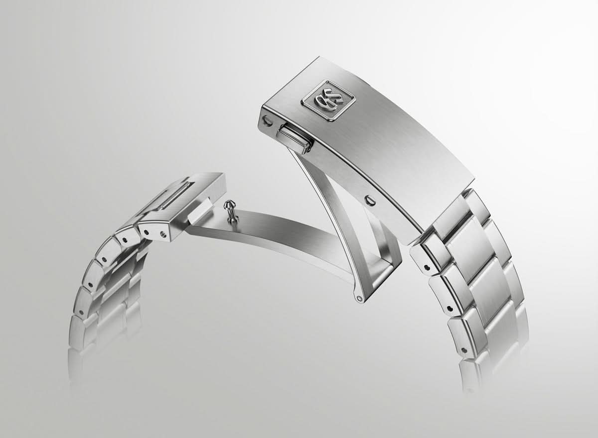 Silver watch band on a light gray background
