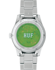 Back of Silver Seiko watch with green back and 'HUF' branding on a white background