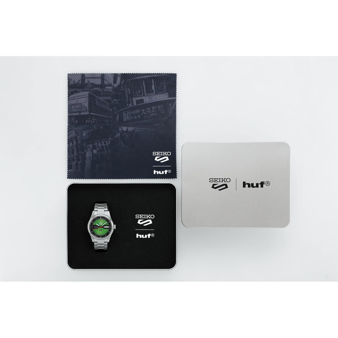 Seiko and HUF branded watch, cloth, and card on a white background