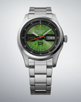 Silver Seiko watch with green face on a light gray background