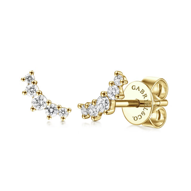 Gold earrings with diamond accents on a white background