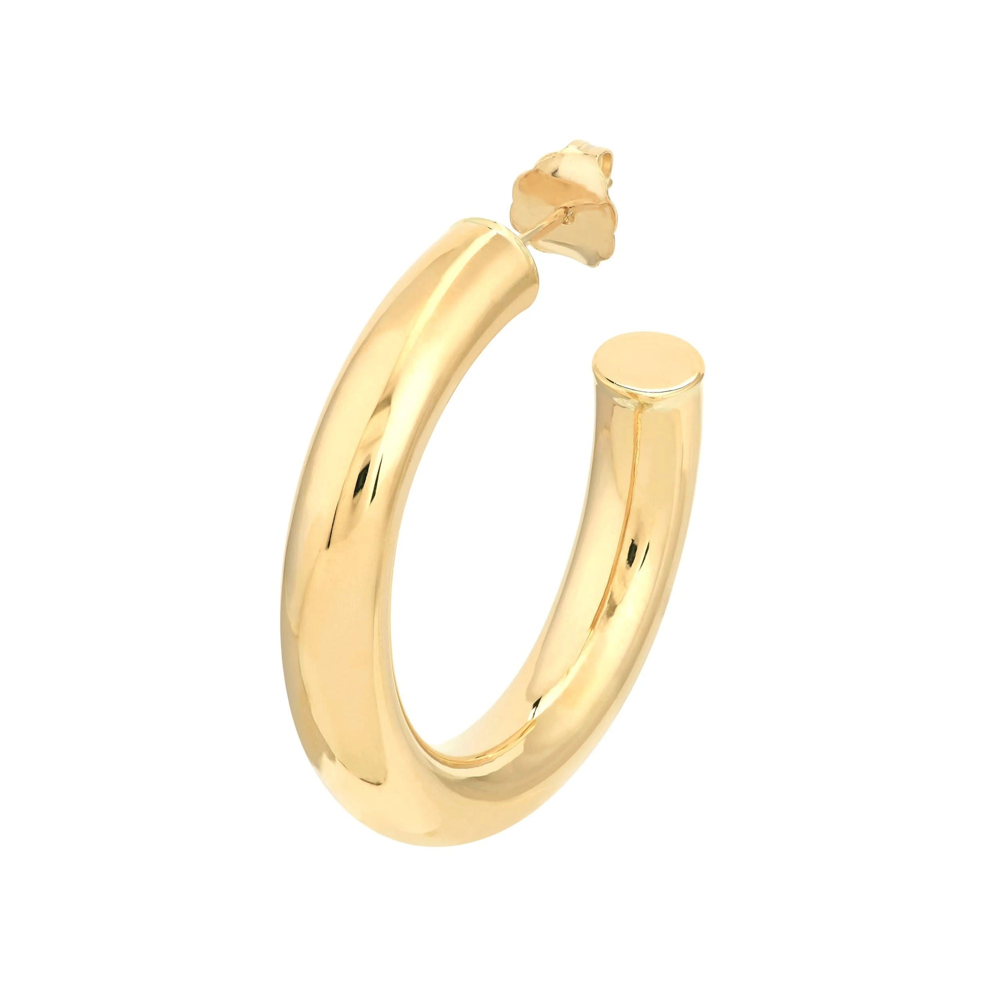 Close up view Gold hoop earring on a white background