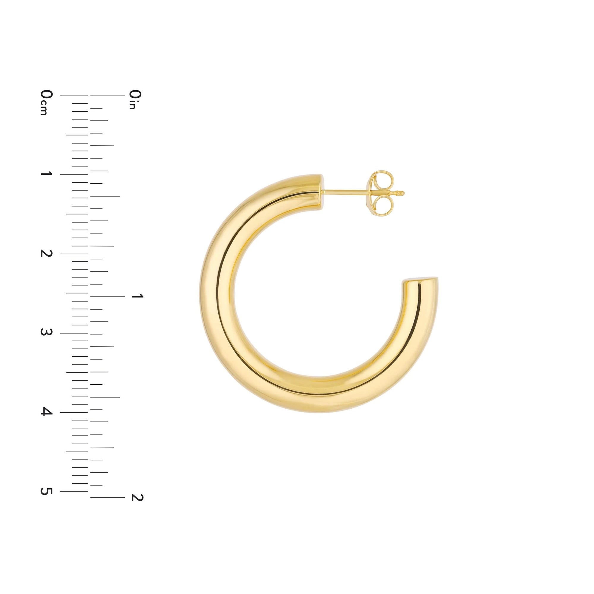 Gold hoop earring with a ruler for scale on a white background