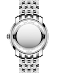 Close-up rear view of a silver stainless steel watch with a metal link bracelet, showing engraved details and branding on the case back against a white background.
