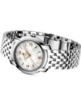 A wrist watch with a silver stainless steel link bracelet, a round silver case, and a white mother-of-pearl dial with gold-tone hands and numerals. The brand name 'breitling' is visible on the dial.