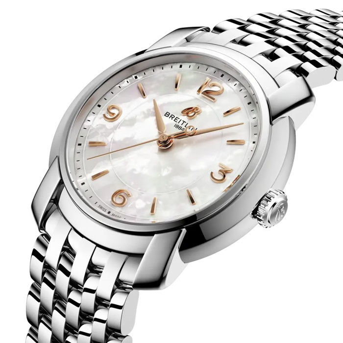 A close-up studio shot of a Breitling wristwatch with a silver stainless steel link bracelet, a white mother-of-pearl dial, and rose gold-tone hands and numeral markers.
