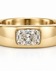 A polished yellow gold ring featuring a rectangular radiant-cut diamond center stone, shown on a clean white background.