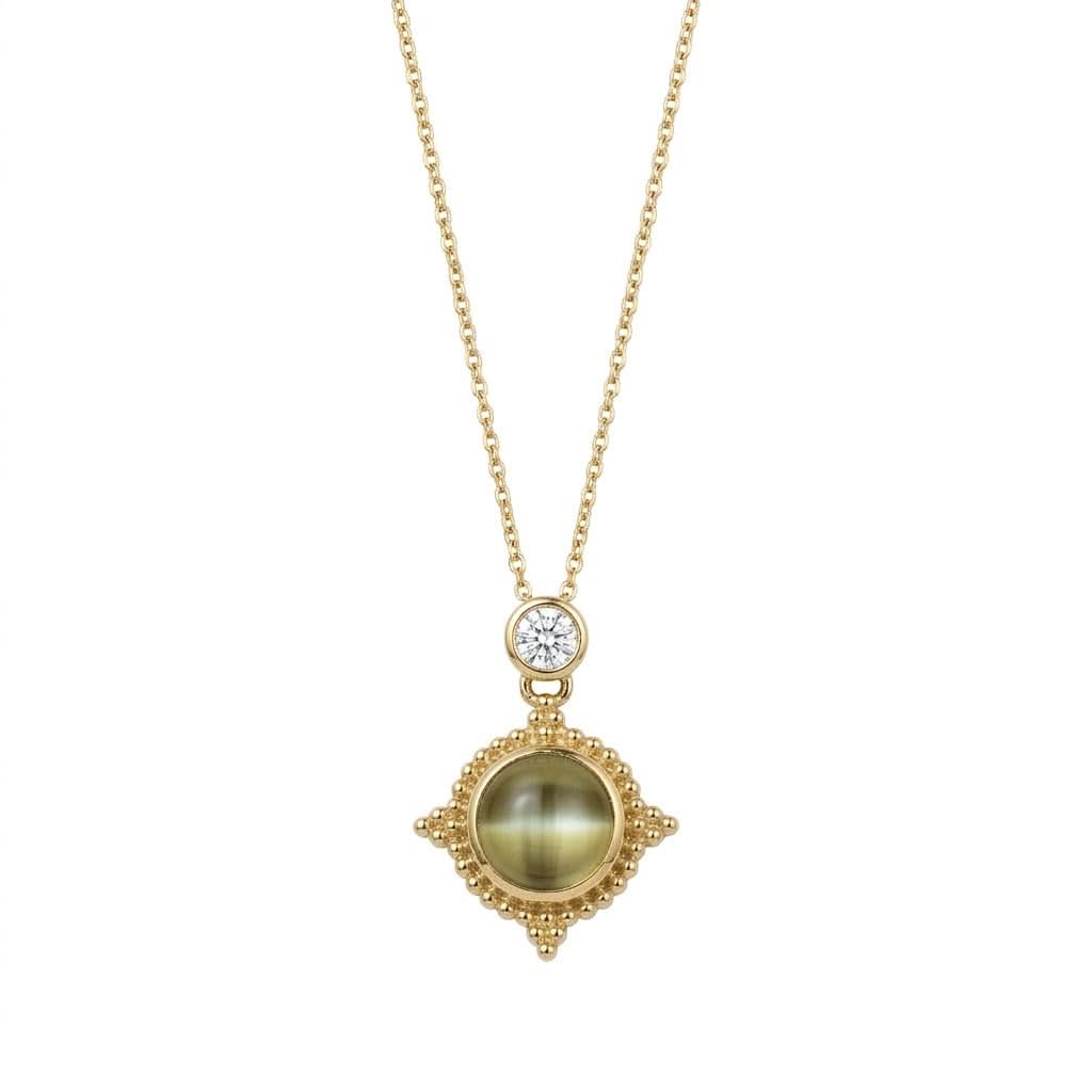 A custom 18K yellow gold pendant necklace by Skeie's Jewelers, featuring a round 1.58 carat cat's eye chrysoberyl cabochon in a beaded bezel medallion, topped by a 0.22 carat round brilliant diamond accent on an 18-inch chain.