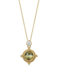 A custom 18K yellow gold pendant necklace by Skeie's Jewelers, featuring a round 1.58 carat cat's eye chrysoberyl cabochon in a beaded bezel medallion, topped by a 0.22 carat round brilliant diamond accent on an 18-inch chain.