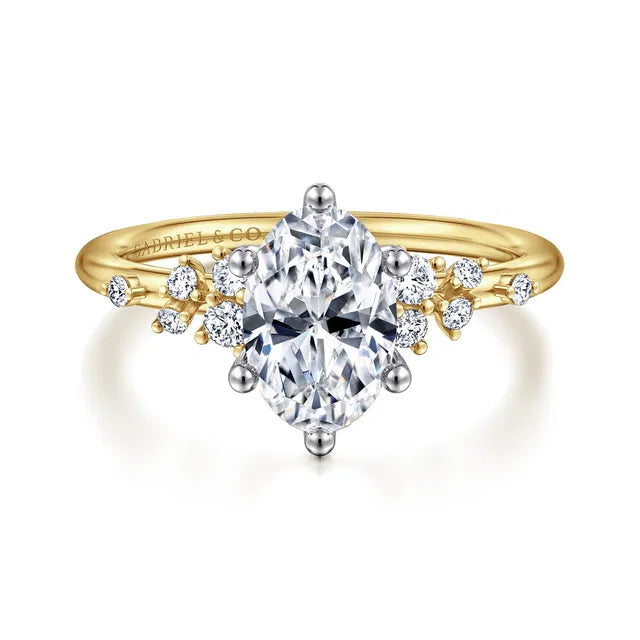 Gold and silver ring with a large central diamond and smaller diamonds on a white background