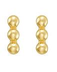 Pair of gold three bead bar design earrings on a white background