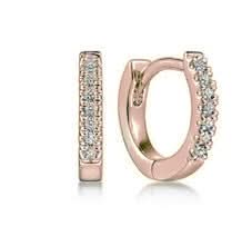 Rose gold hoop earrings with diamond gemstones on a white background