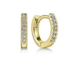 Gold hoop earrings with embedded diamonds on a white background