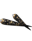 Angled view of Logan James Talon PS long tapered black steel earrings with 18K and 22K yellow gold details and diamonds