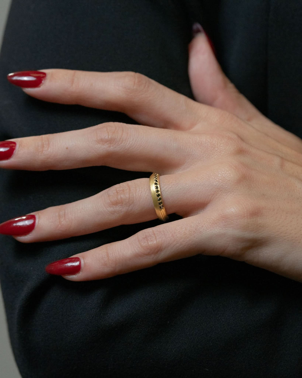 Logan James Urban yellow gold black diamond band styled on hand