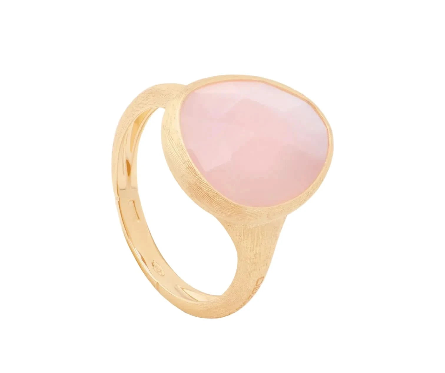 A gold signet ring featuring a large, smooth, oval-shaped pale pink stone, photographed on a clean off-white background.