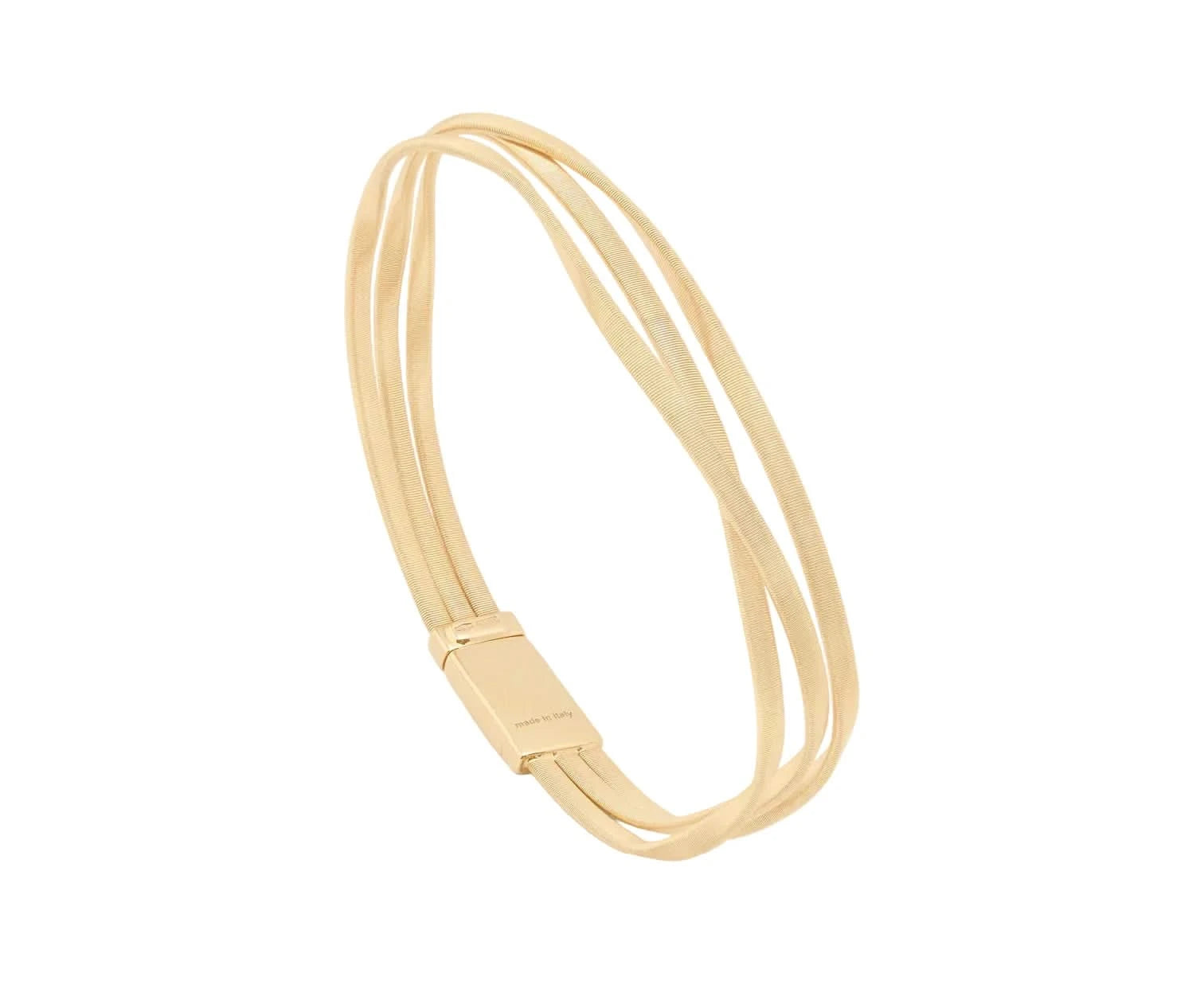 Gold triple strand bracelet on a light beige background