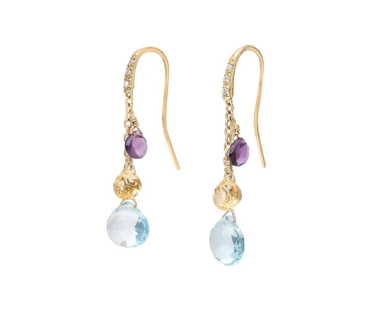 A pair of gold drop earrings featuring a small purple  gemstone, a textured gold gemstone, and a faceted light blue teardrop gemstone, shown against a light off-white background.