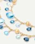 Gold and blue beaded double strand bracelet on a white background close up