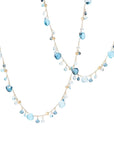 Two layered necklaces with blue and gold beads on a light background