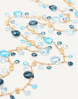 Necklace with blue and gold beads on a white background laid out